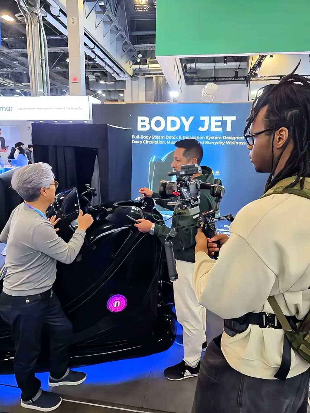 A camera operator records a BODYJET demonstration in U-MINE's CES 2026 event photo