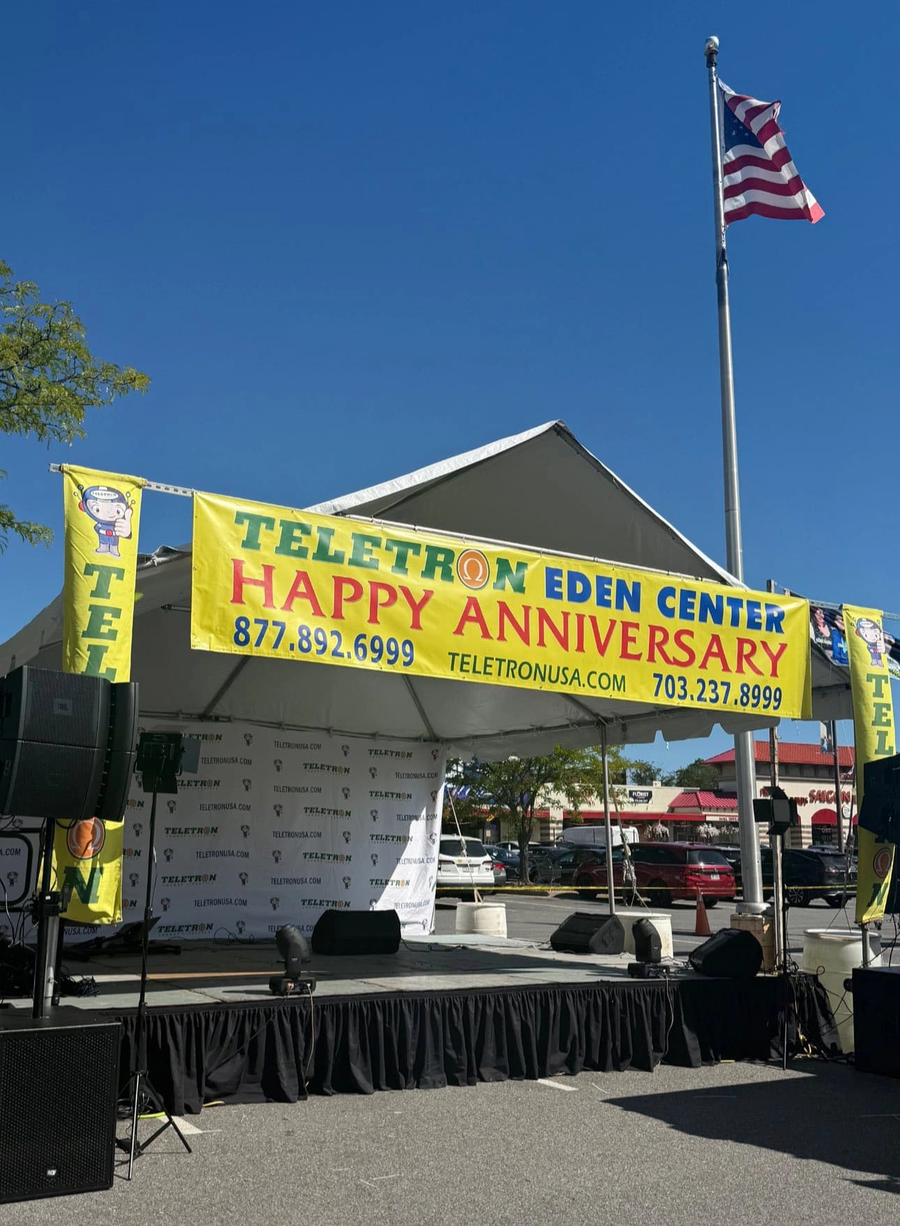 Teletron Eden Center outdoor event stage with its original anniversary banner