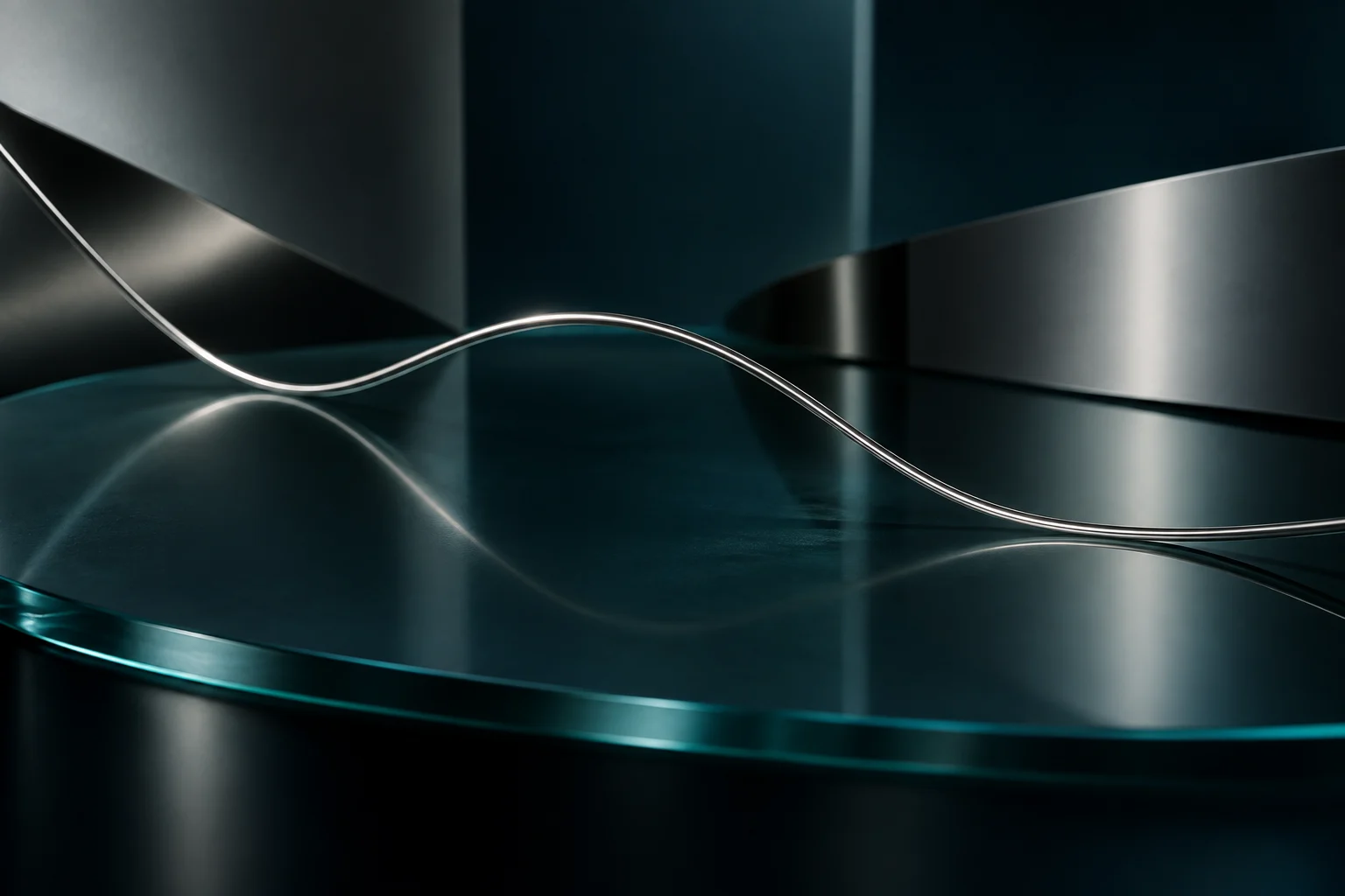 Abstract silver wave with a restrained teal reflection in a dark studio