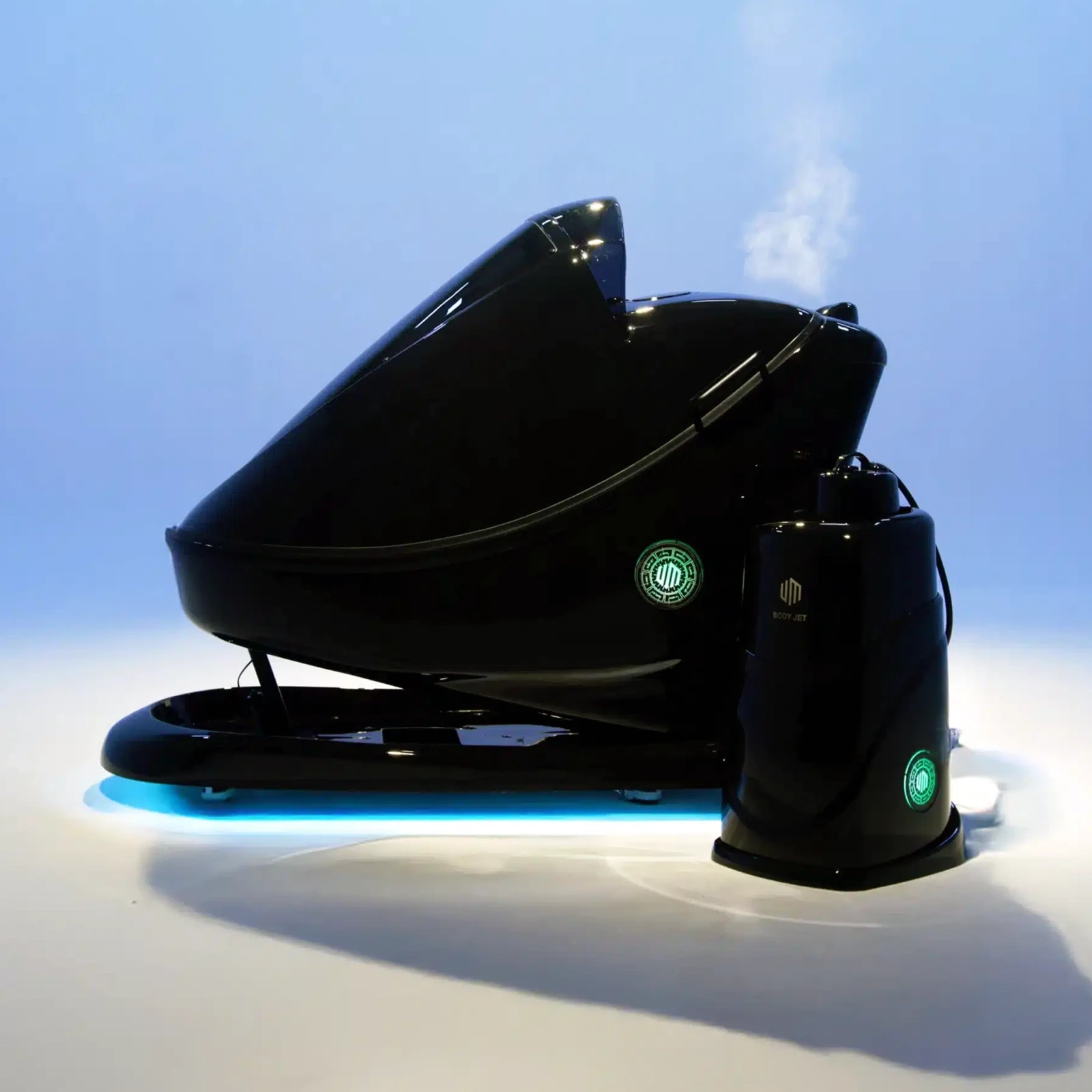 Black BODYJET and its separate tower in a blue studio, with steam above the enclosure