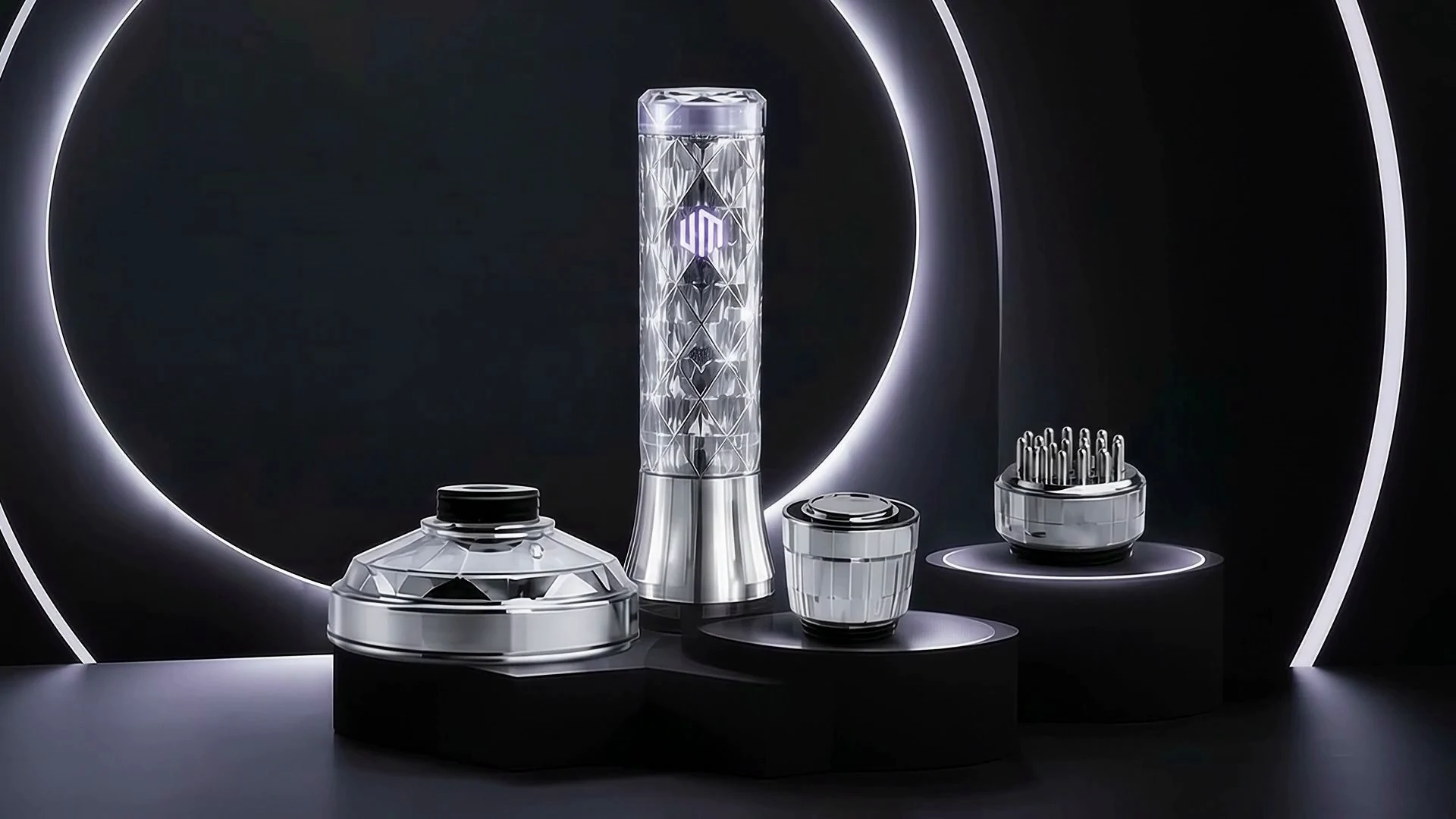 The silver U-MINE K device and its interchangeable contact heads in a dark studio setting.