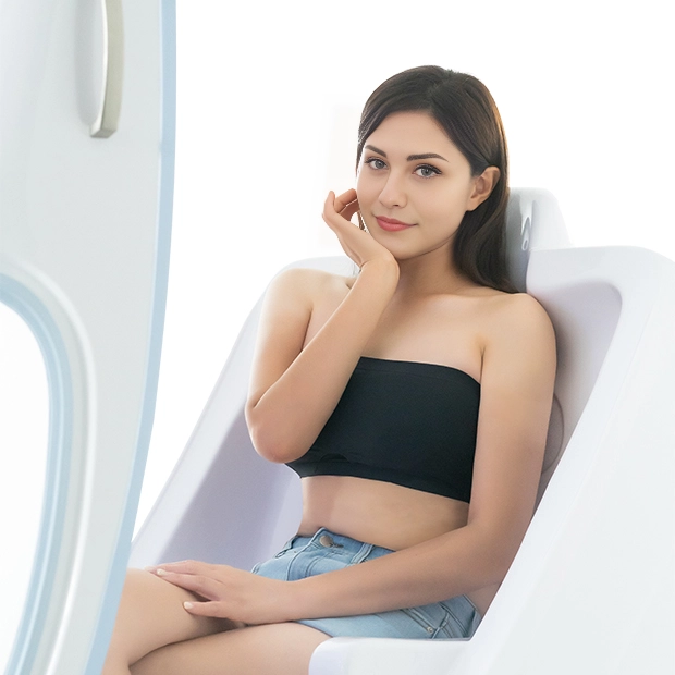A woman sitting comfortably inside the U-Mine BodyJet steam spa, enjoying a relaxing and rejuvenating wellness session.