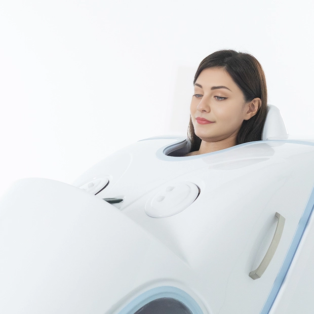 A woman relaxing inside the U-MINE BodyJet steam spa, enjoying a full-body detox session.